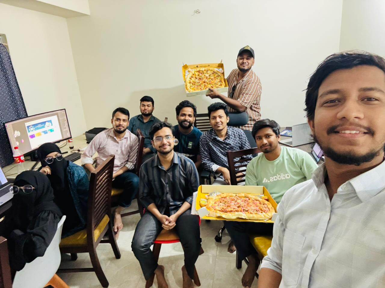 LozicLabs team sharing pizza in the office